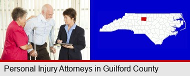 injured person consulting with a personal injury attorney; Guilford County highlighted in red on a map