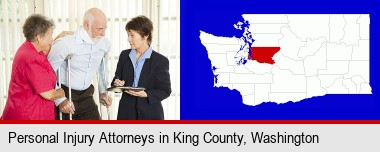 injured person consulting with a personal injury attorney; King County highlighted in red on a map