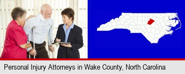 injured person consulting with a personal injury attorney; Wake County highlighted in red on a map